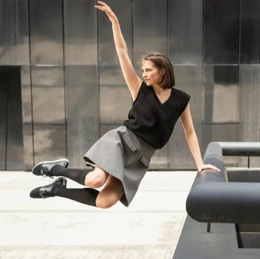 Knee-high compression stockings in black, closed toe, on model’s legs