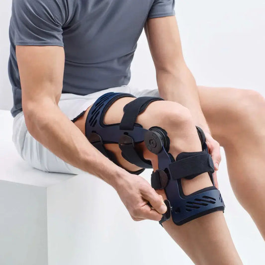 Blue knee brace with cross bracing straps on lower leg