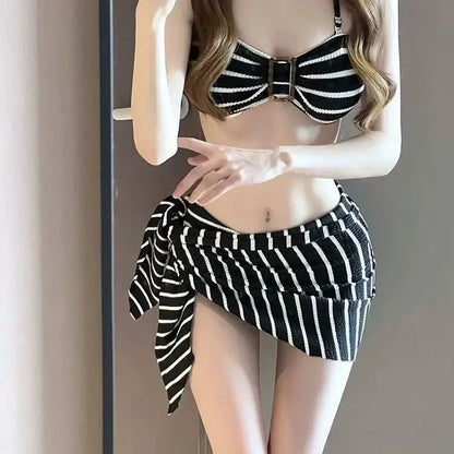 Women's black-and-white striped halter bikini top with matching wrap skirt bottom
