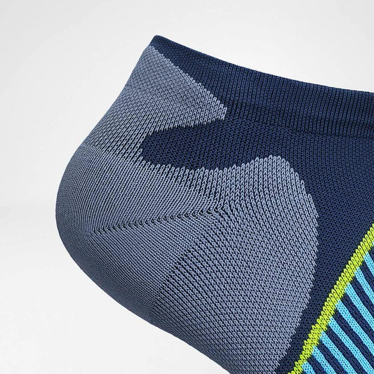 Low-cut performance socks with navy panels, light blue stripes, and neon green accents