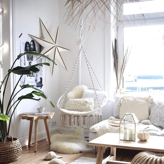 Cream macrame hanging swing chair with netted seat and knotted fringe
