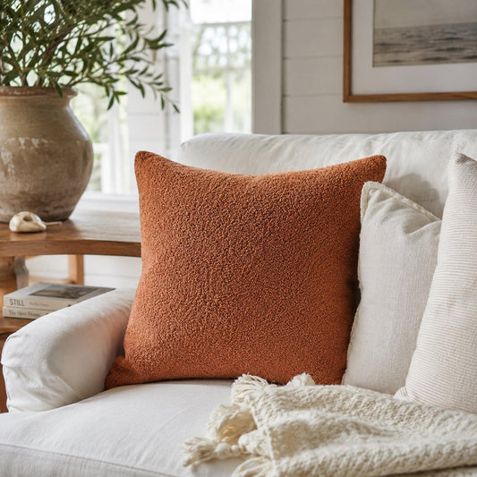 Rust boucle teddy cushion cover with insert, textured plush front on sofa