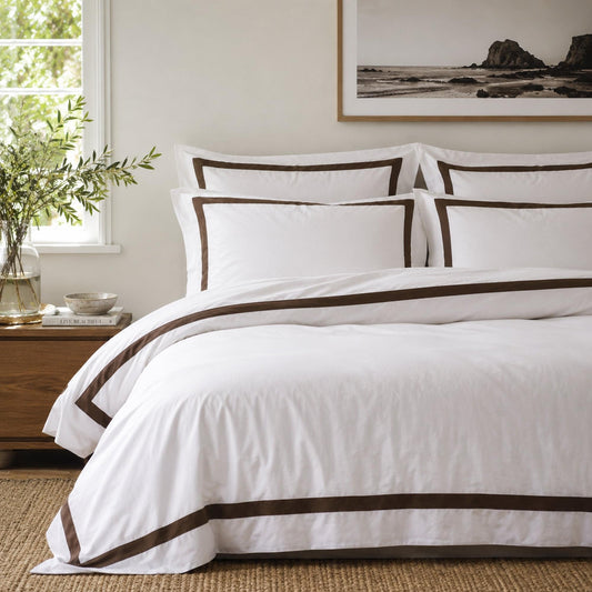 White quilt cover set with brown contrast trim, neatly trimmed bed linen