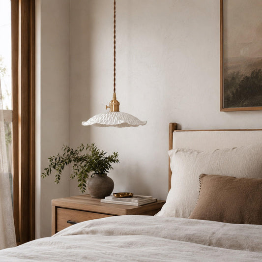 Pendant light with white scalloped ceramic shade and braided cord, brass-toned socket