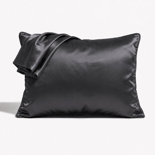 Charcoal satin pillowcase set with envelope closures, smooth glossy finish.