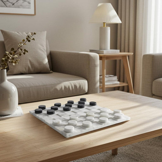 Marble checkers set on a tabletop with white grid and black and white round pieces