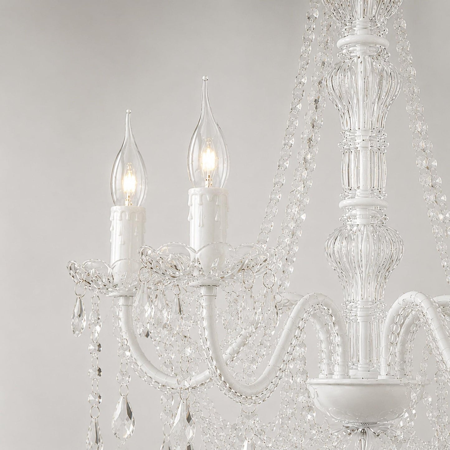 Clear flame-tip candle bulbs in a chandelier, E14 screw bases visible