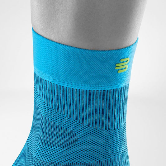 Blue compression ankle sleeve with ribbed knit and logo at the outer ankle