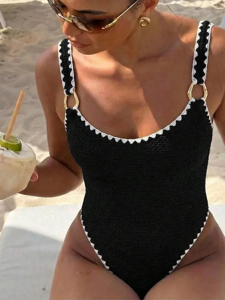 Women’s one-piece swimsuit, black with white trim, sleeveless V-neck, high cut
