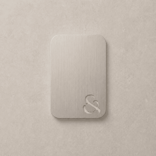 Brushed nickel color swatch card with metal emblem, rounded corners