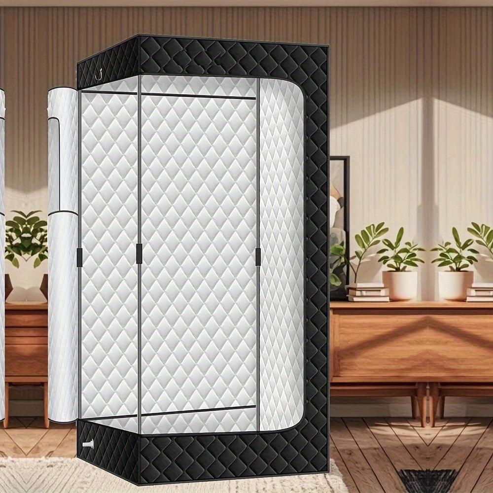 Portable sauna tent with black quilted cover and white inner privacy panels