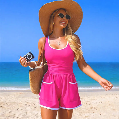 Pink one-piece tank swimsuit with white contrast trim and side pockets, front view