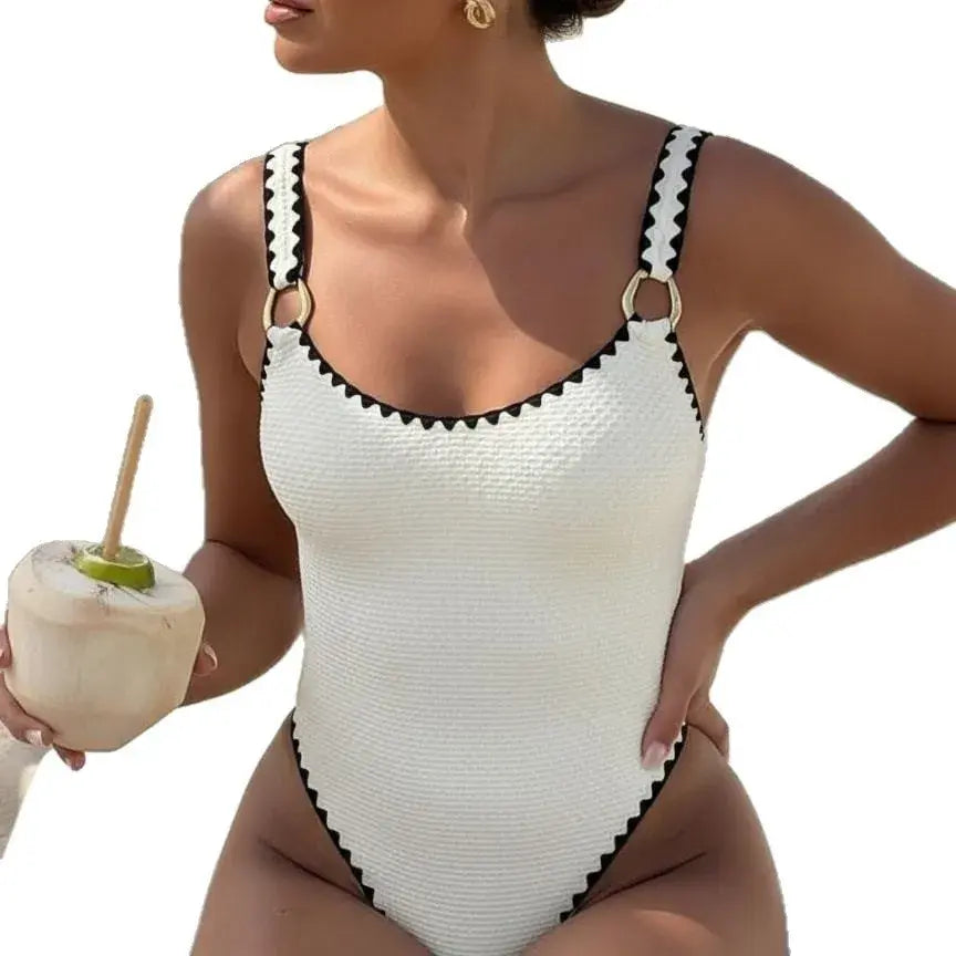 Women’s white one-piece swimsuit with black trim, sleeveless V-neck, high cut