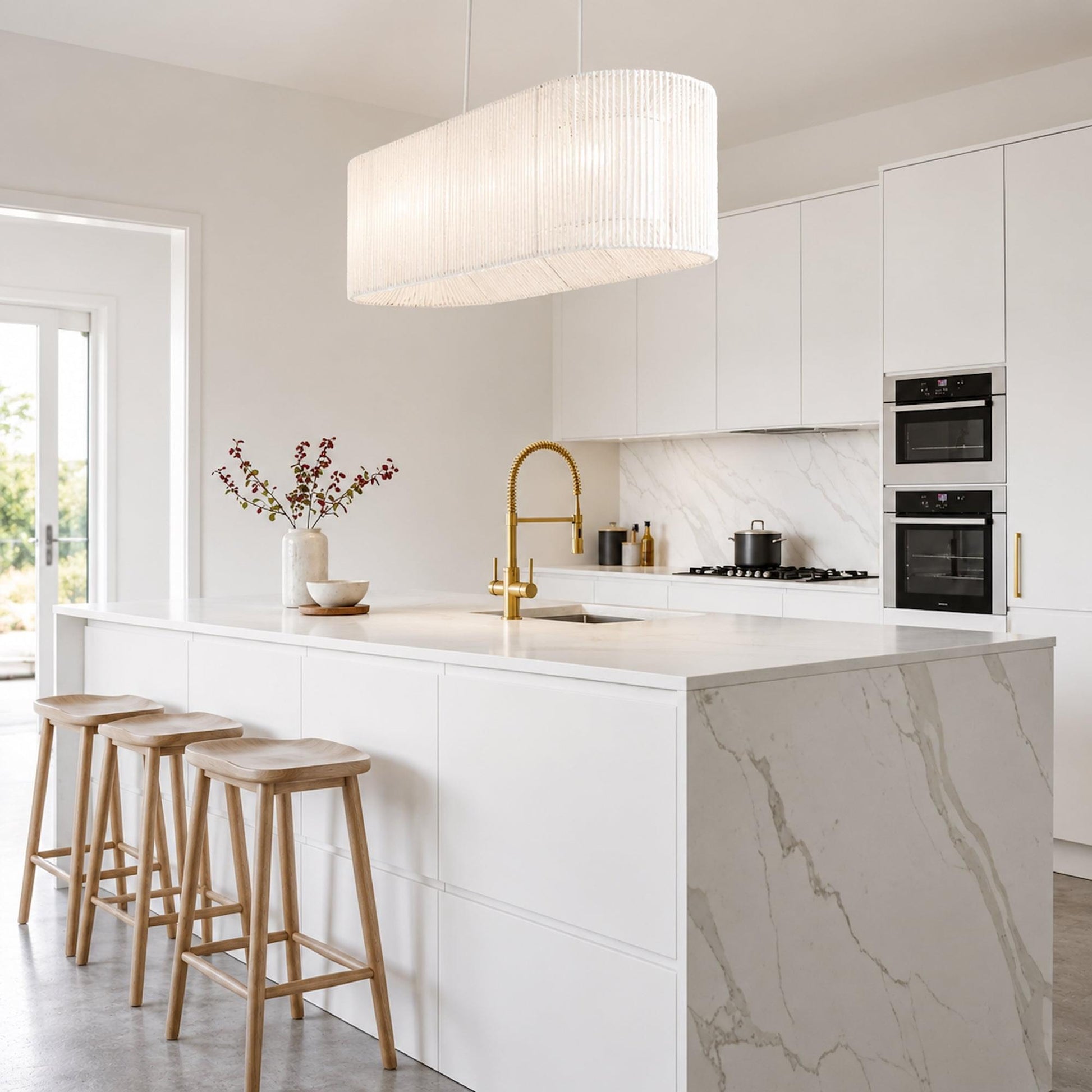 White rope pendant light with arched drum shade hanging from the ceiling
