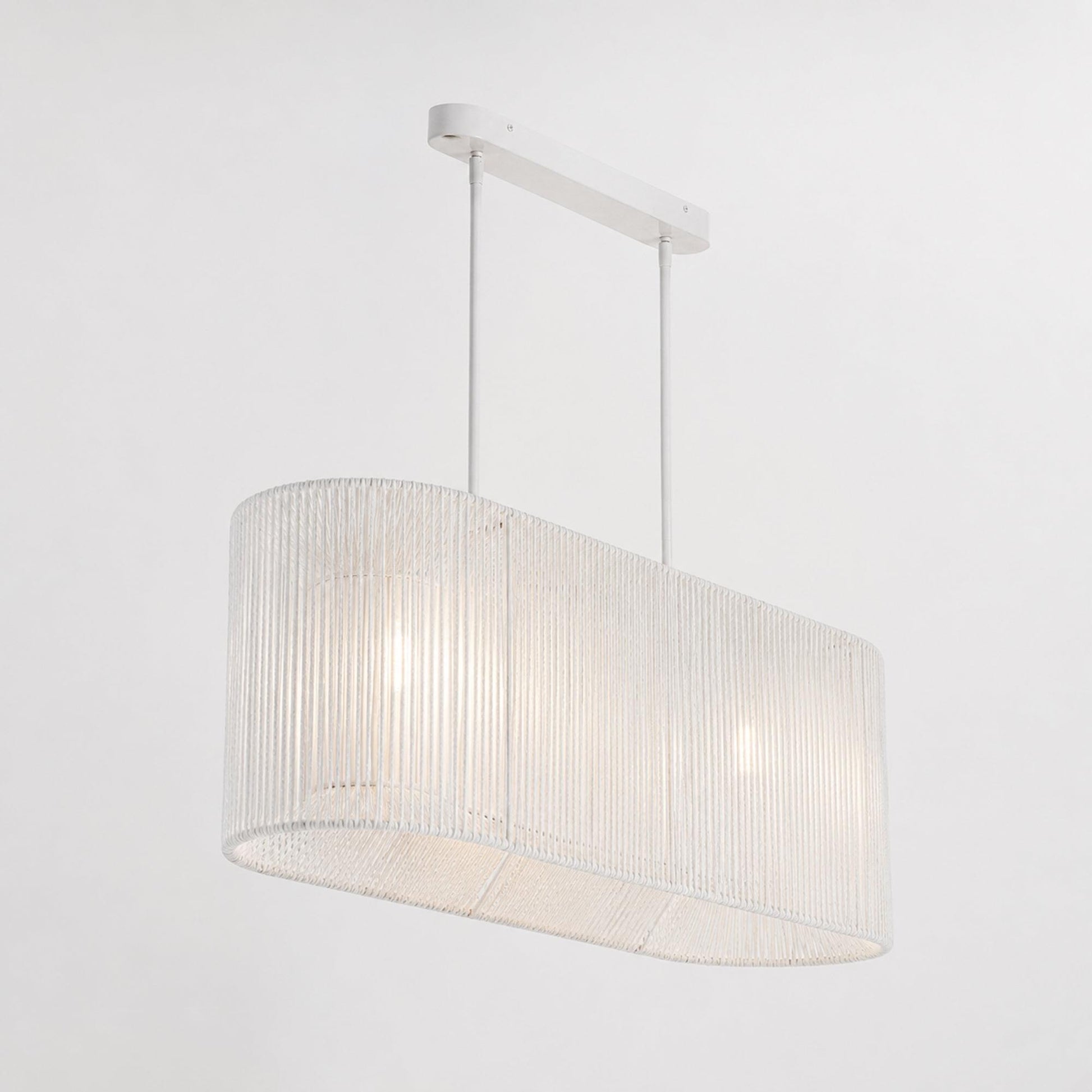 White rope pendant light with drum-shaped fabric shade and hanging rod