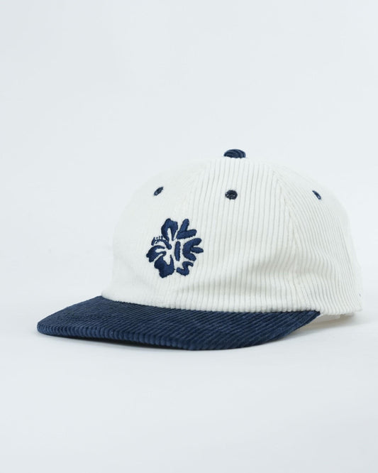 Ribbed knit cap with navy brim, blue flower and dot accents on white crown