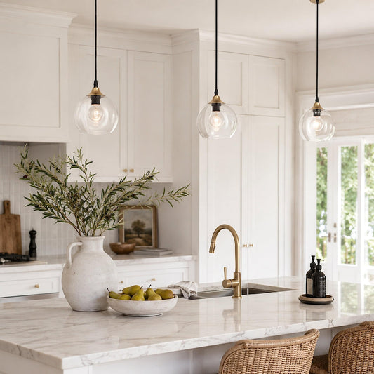 Clear glass globe pendant with black cord and gold metal cap, multiple lights shown