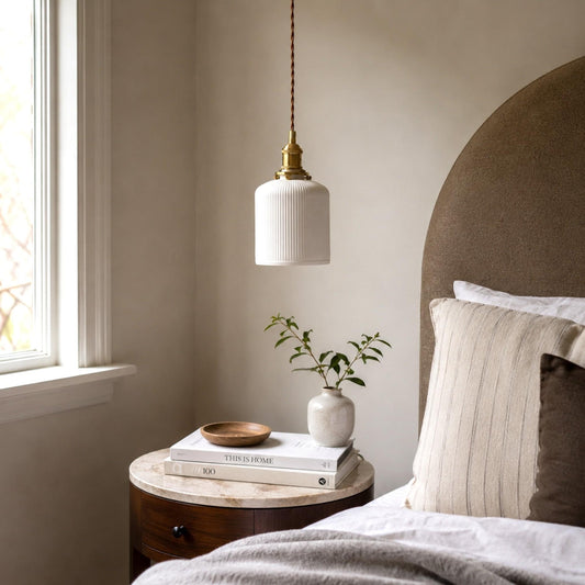 White ceramic pleated pendant light with brass socket and ribbed shade