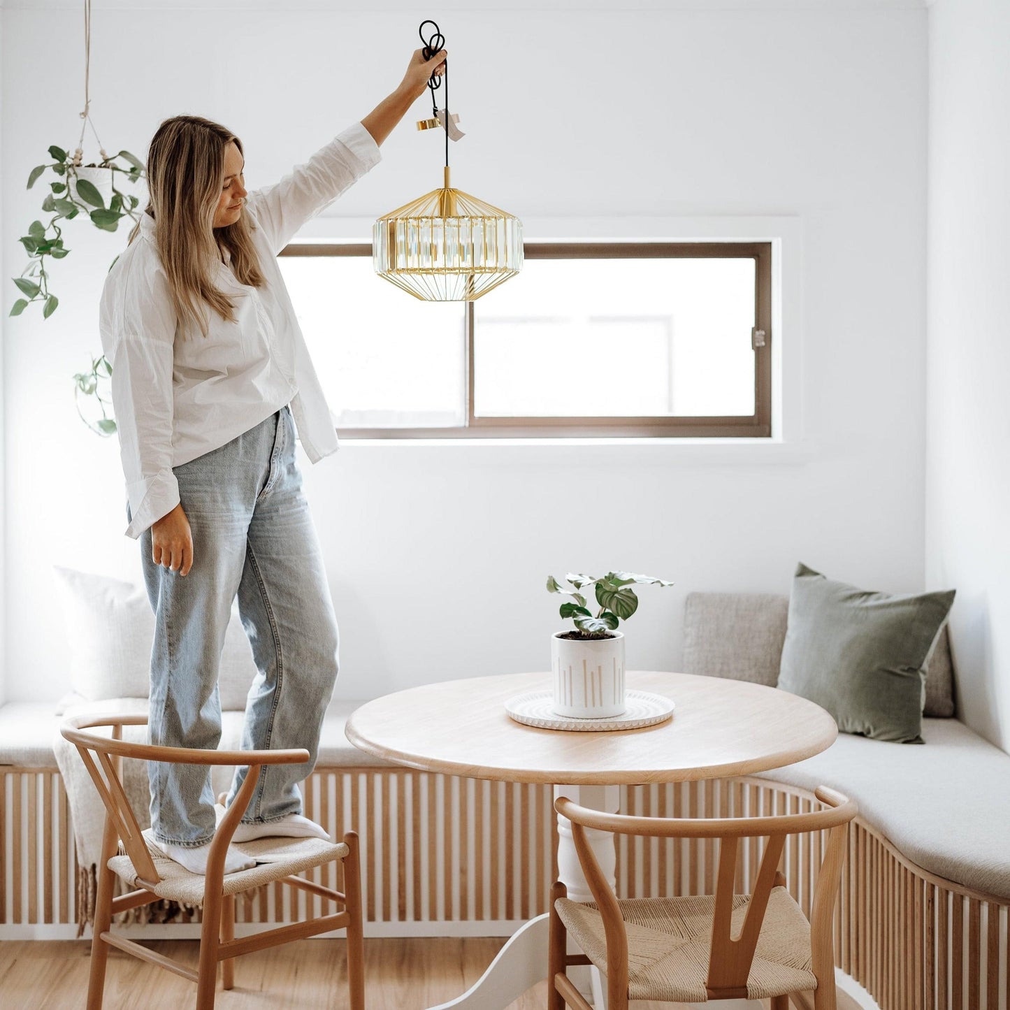 Gold prism glass pendant light with faceted clear shade, hanging on cord and chain