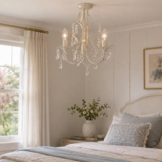 White 3-light chandelier above bed, with curved arms and crystal drop strands