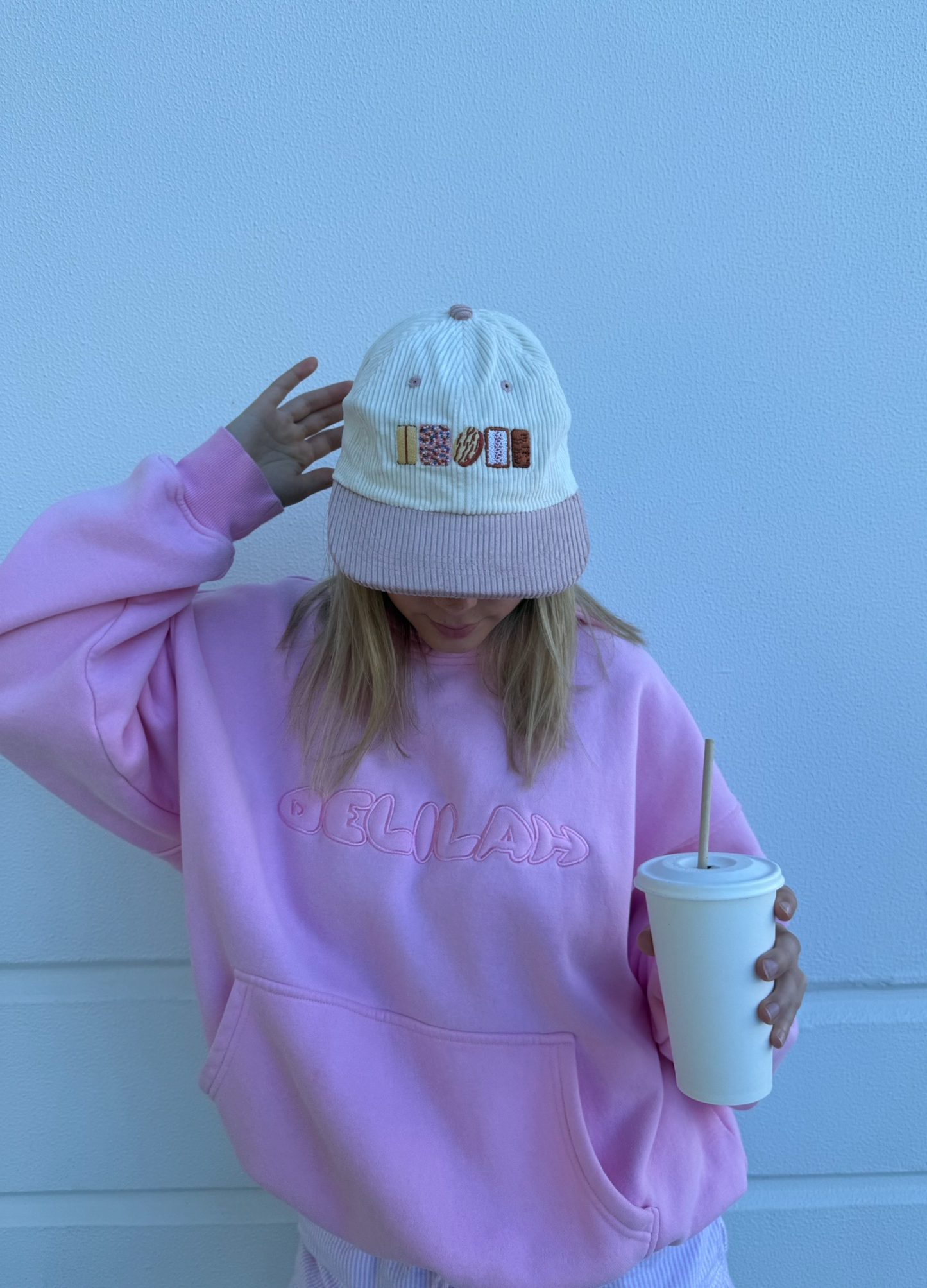 Knit cap back view, small 'AUSSIE' logo, ribbed mauve brim