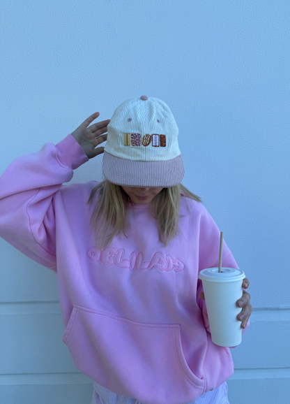 Knit cap back view, small 'AUSSIE' logo, ribbed mauve brim