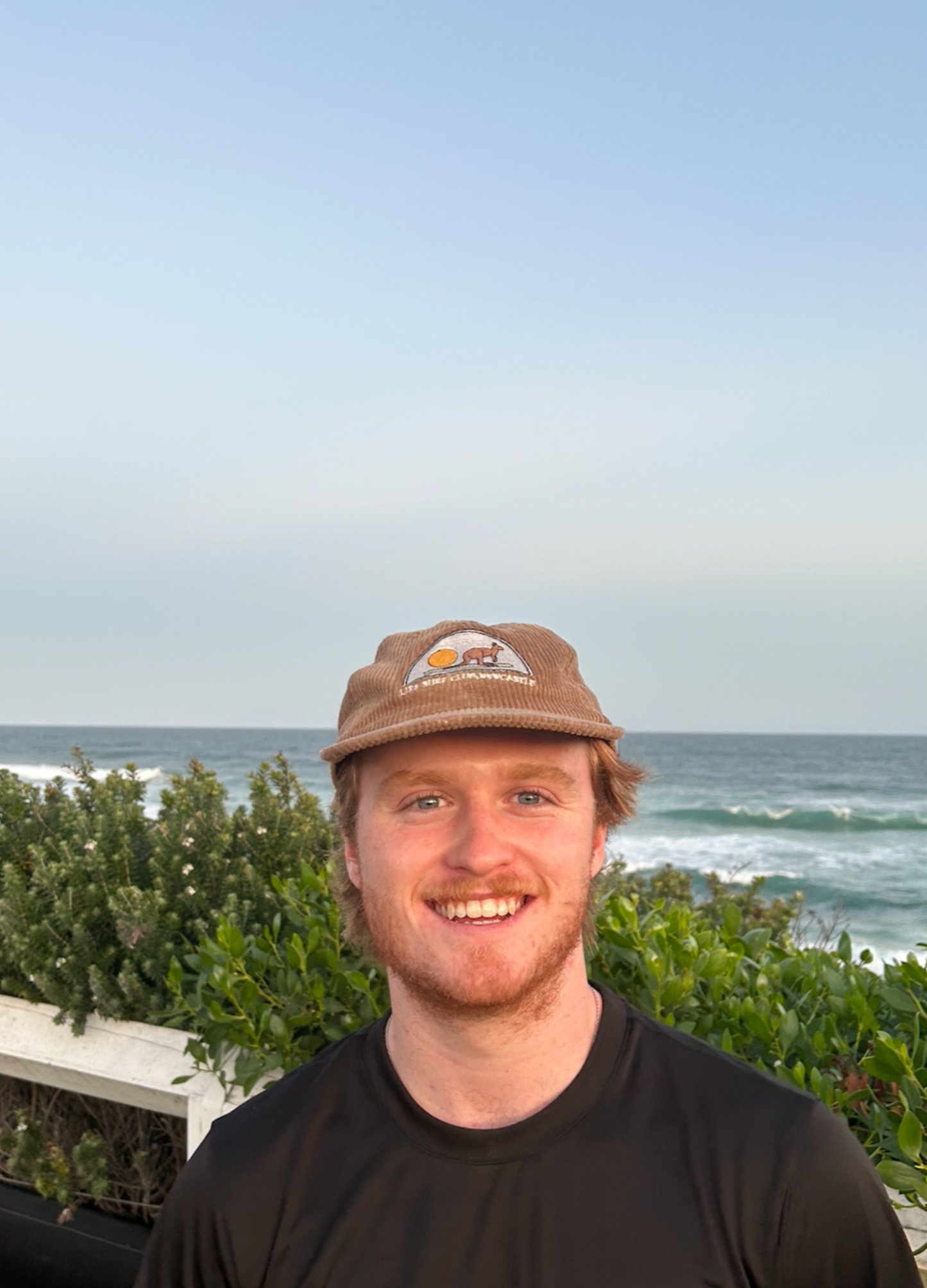 Tan corduroy baseball cap with embroidered patch on front
