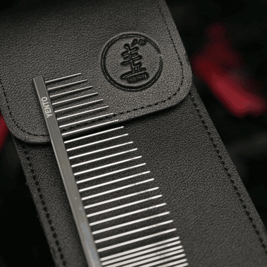 Close-up of metal teeth hair comb in black leather-look case with logo patch