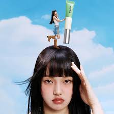 Woman holding mint-green hair sebum hair mascara tube above straight bangs