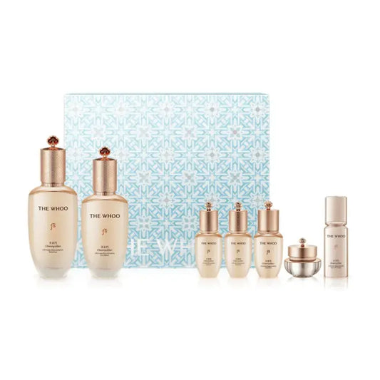 7-piece skincare set with multiple bottles and jars in gold-toned caps