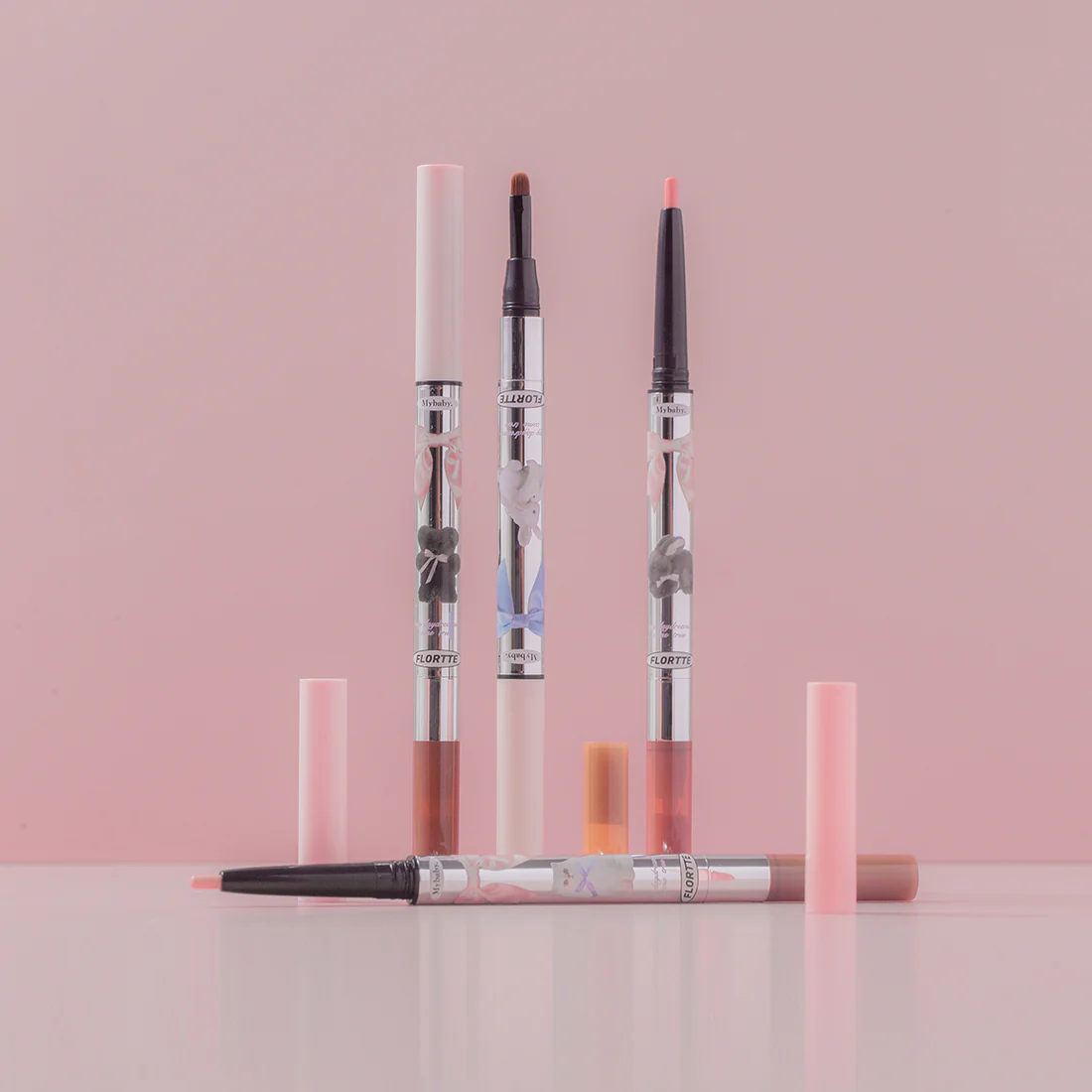Two double-ended eyeshadow pencils with light and dark color tips