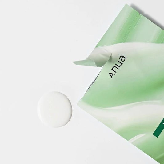 Sheet mask pouch with Anua logo and green packaging corner, shown with white patch
