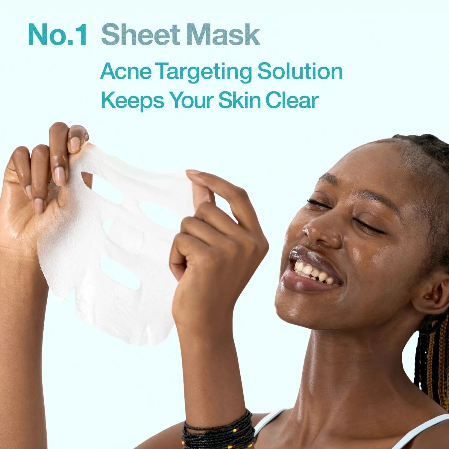 Person applying a white num buzin No.1 sheet mask on face