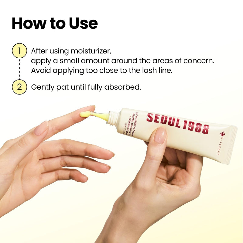 Eye cream tube held in hands with small yellow cream on fingertips