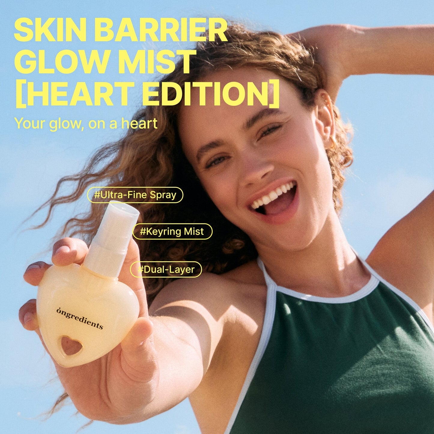 Heart-shaped glow mist bottle held by smiling woman, spray nozzle visible