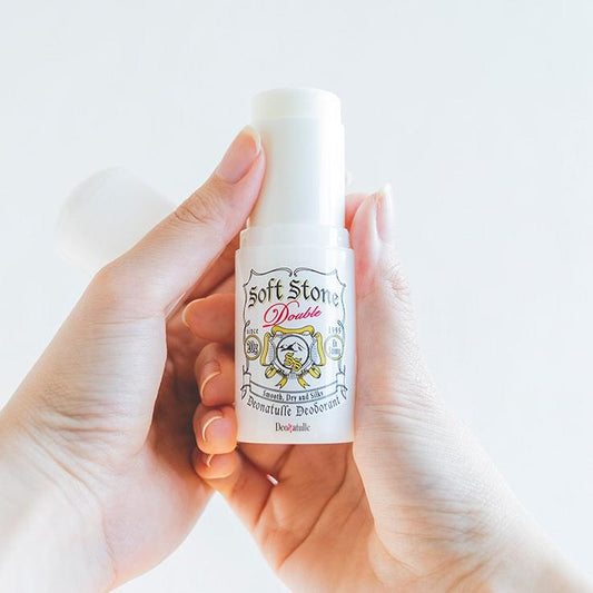Deonatulle Soft Stone deodorant stick, white canister held in hands