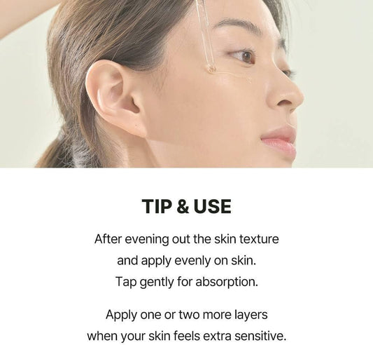 Facial serum dropper applying clear serum to skin
