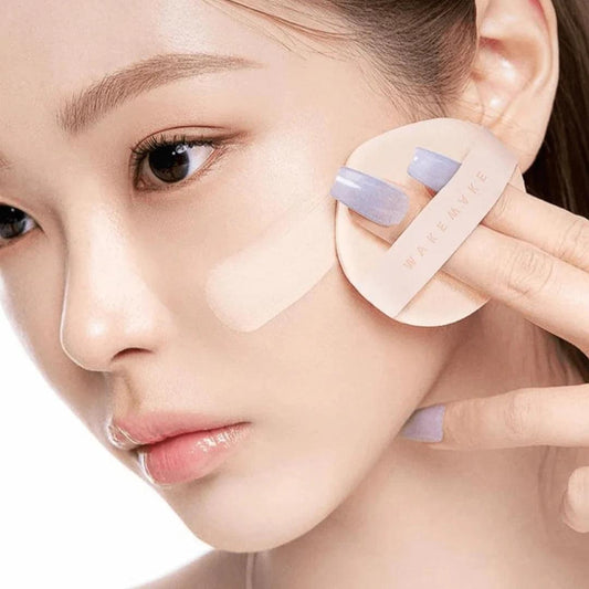 Water glow coating balm on hand touching a skin-toned balm disc