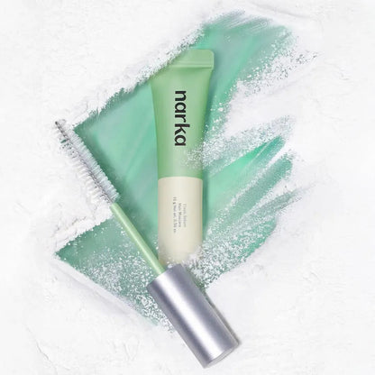 Hair sebum hair mascara with mint tube and brush, shown on light green gel