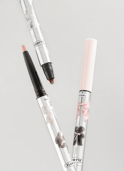 Two retractable double-ended eye pencils with cream and dark tips in close-up