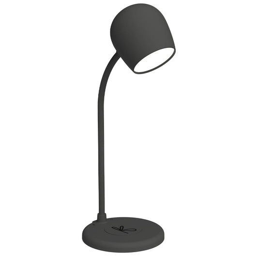 Black desk lamp with adjustable shade and circular base, warm light glow