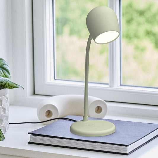 Dusty olive desk lamp on base with fabric shade, placed on tabletop