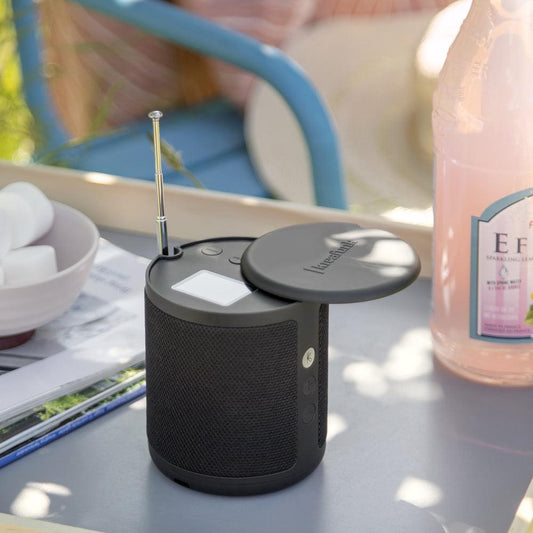 Black portable radio speaker with antenna post, top button panel, and compact body