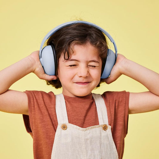 Kids ear muffs in cloudy blue with black pads, worn by a child
