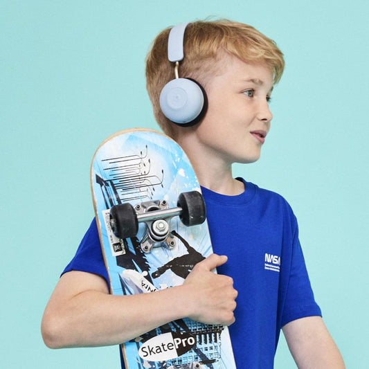 Kids over-ear Bluetooth headphones in cloudy blue with black cushions, worn on child