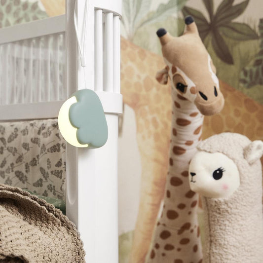 Dusty green cloud lamp wall sconce with soft glow on white pole
