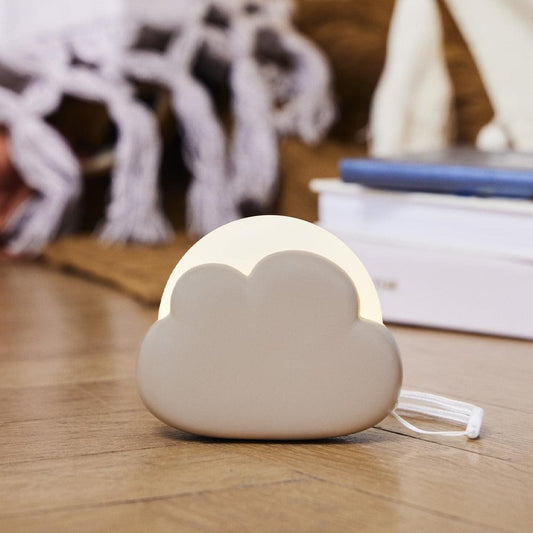 Ivory cloud night lamp with built-in pull cord, on wooden surface