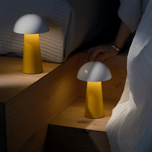 Two portable table lamps with white dome shades and mango orange bases