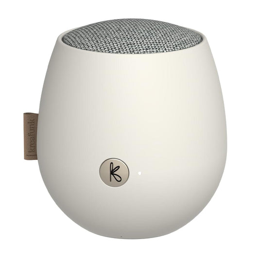 White Bluetooth speaker with fabric top and circular K logo on front
