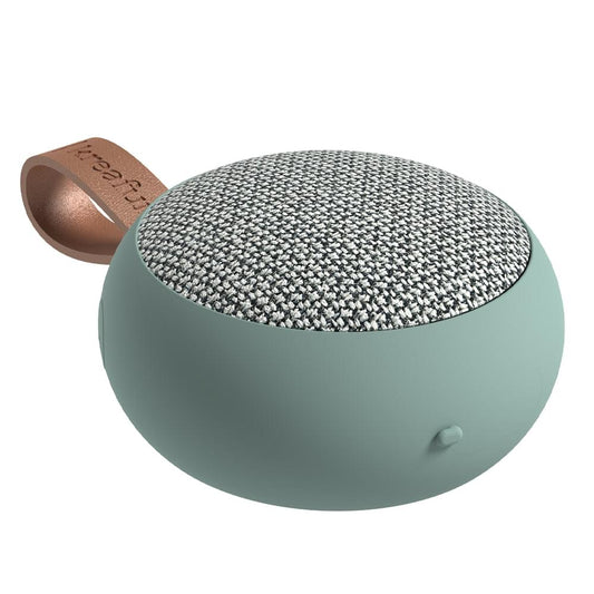 Dusty green fabric Bluetooth speaker with textured top grille and leather strap loop